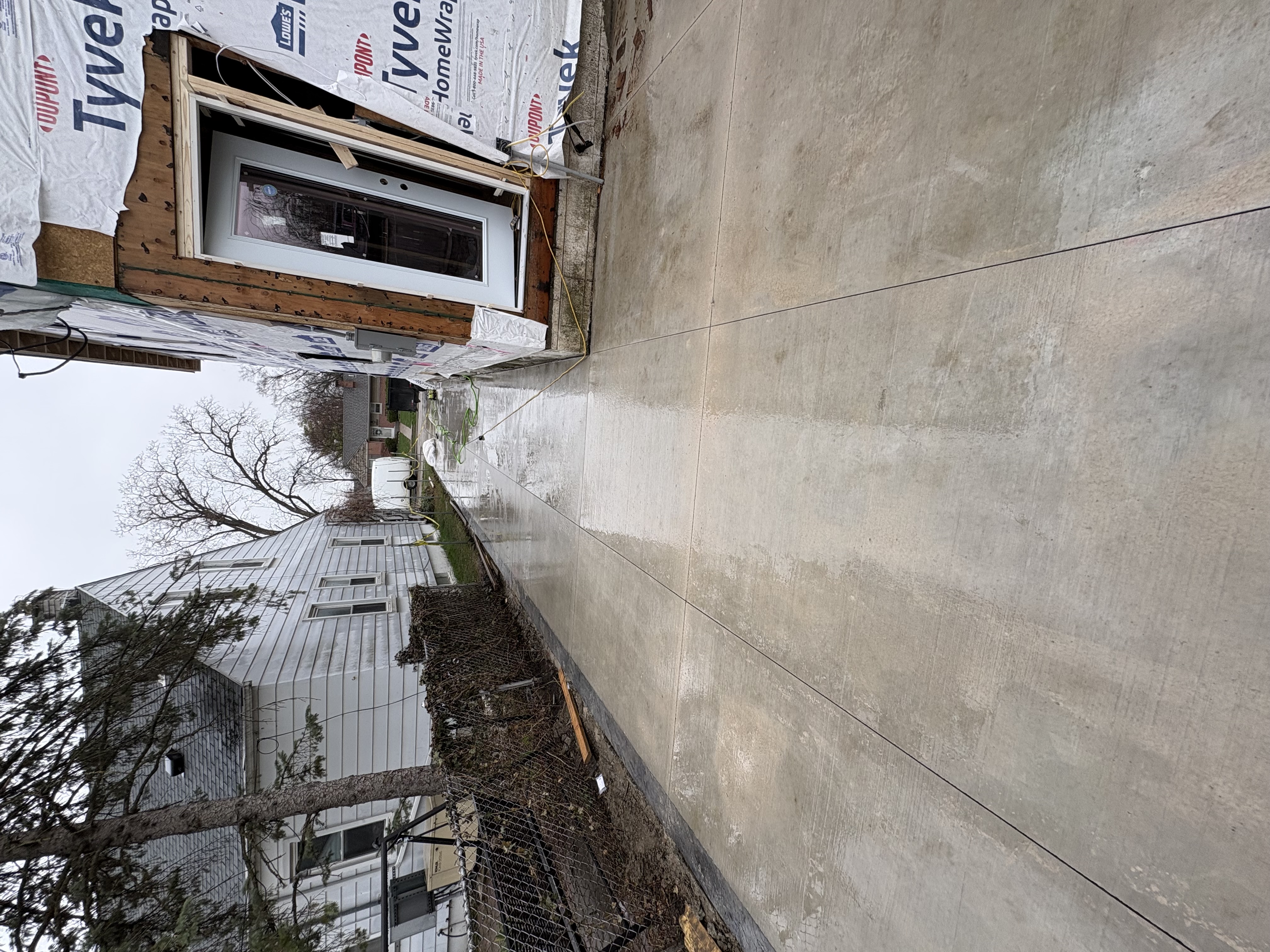 Broom-finished concrete driveway extending to street