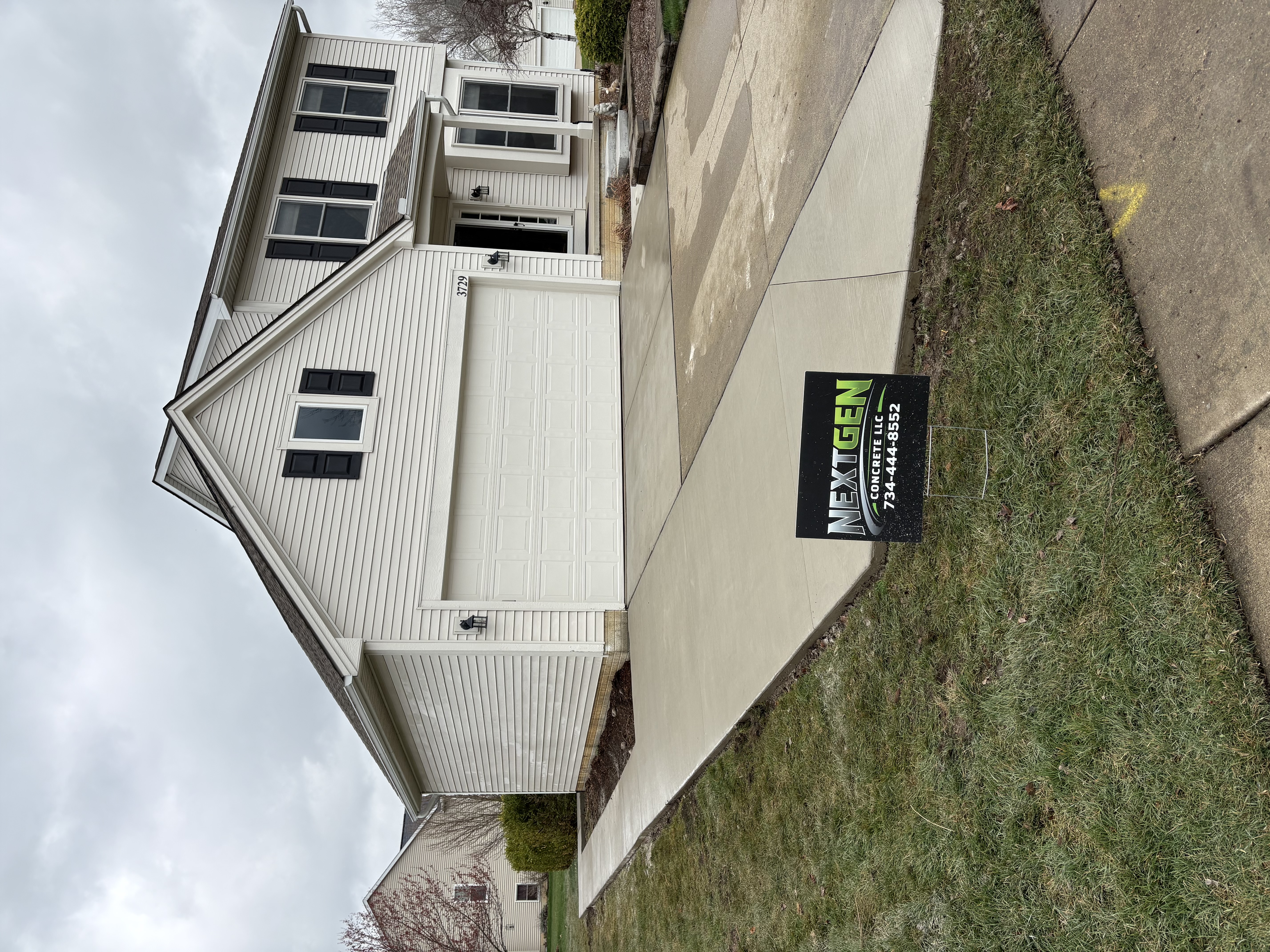 Completed concrete driveway with clean edges at residential home