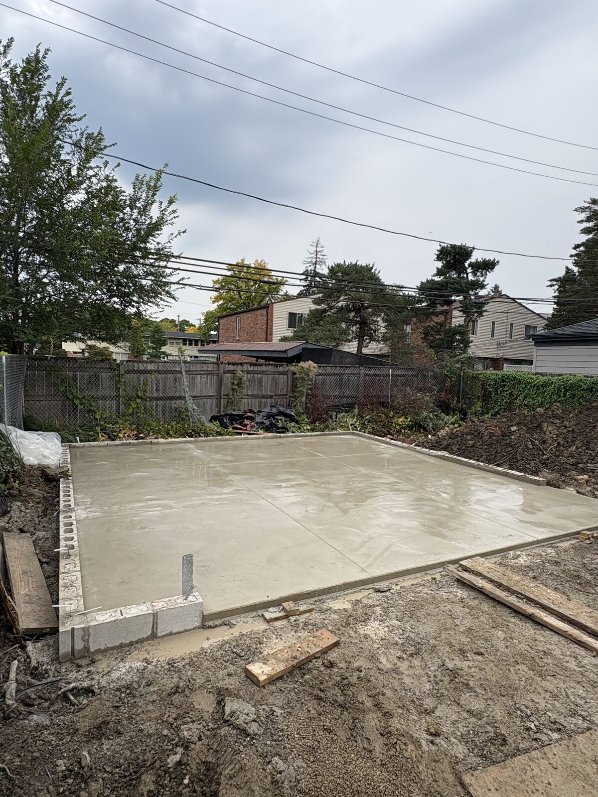 Finished concrete foundation slab on block footing at backyard build