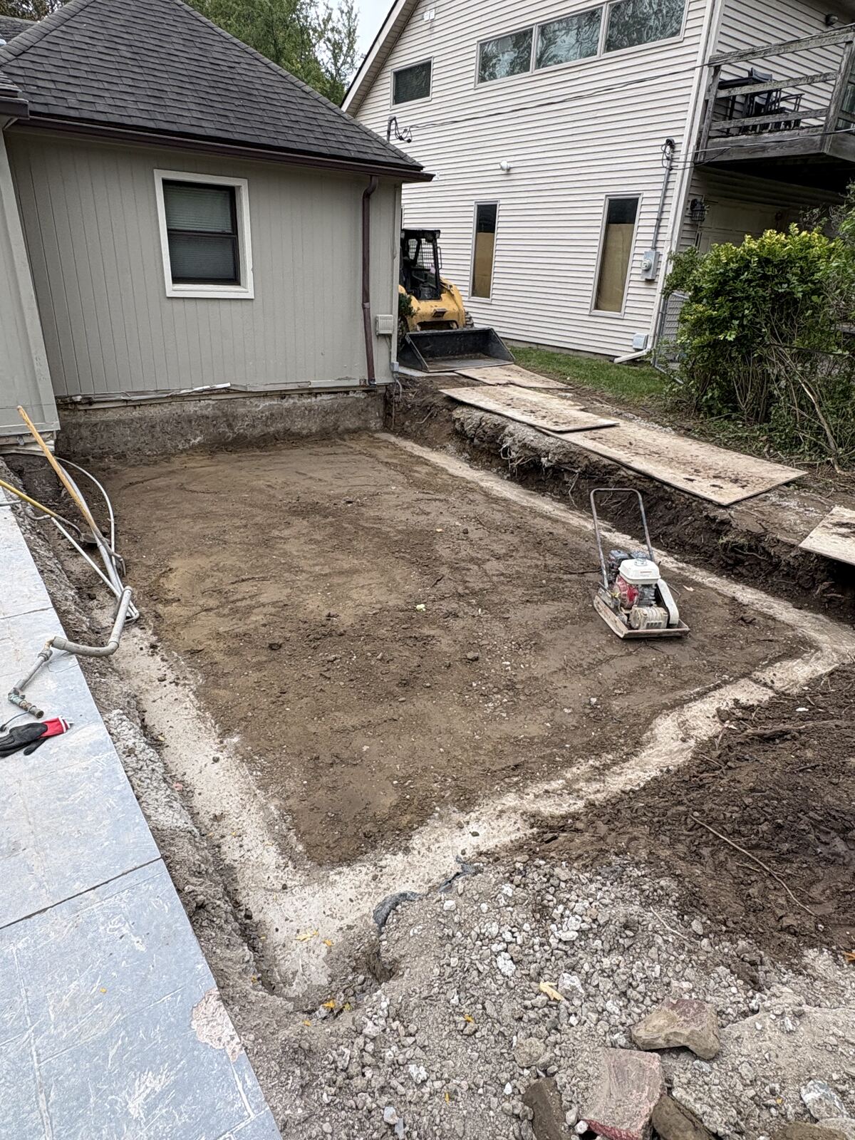 Compacted foundation base inside poured footings with plate compactor